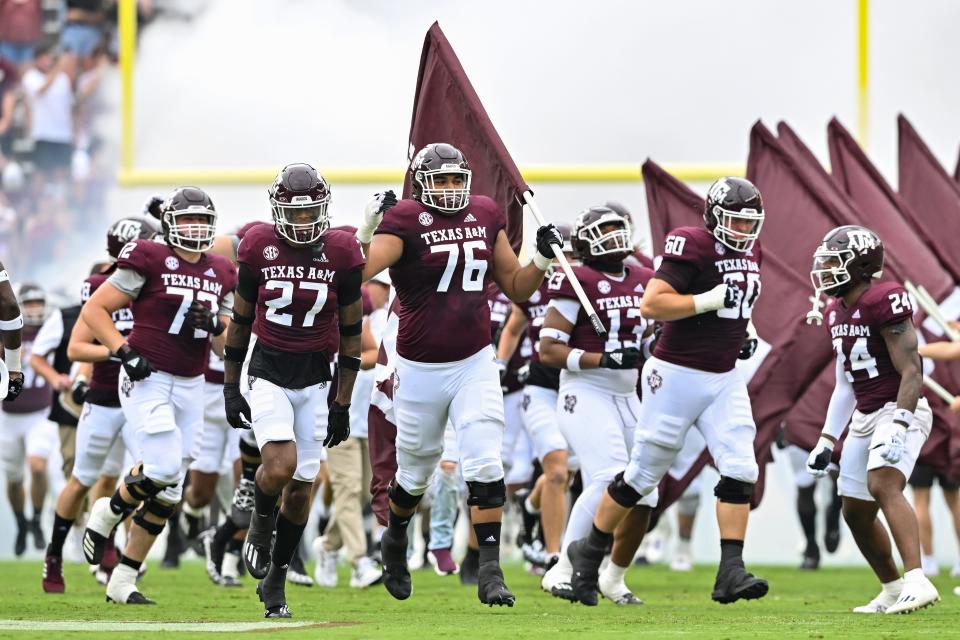 Sep 3, 2022; College Station, Texas, USA; Texas A&M Aggies offensive lineman Reuben Fatheree II (76) carries the flag as he runs out prior to the game against the Sam Houston State Bearkats at Kyle Field. Mandatory Credit: Maria Lysaker-USA TODAY Sports