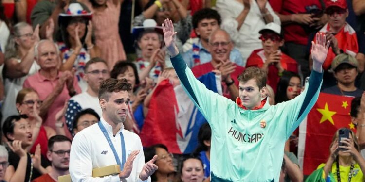 Hungary's Hubert Kos, right, celebrates after winning gold in the men’s 200-meter backstroke. Kos has transferred to Texas from Arizona State this summer and will compete for the Longhorns this upcoming season.