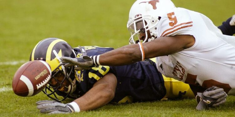 Jan 1, 2005; Pasadena, CA, USA: FILE PHOTO; Michigan Wolverines wide receiver Jermaine Gonzales (18) in action against Texas Longhorns cornerback Tarell Brown (5) during the 2005 Rose Bowl at the Rose Bowl. The Longhorns defeated the Wolverines 38-37. Mandatory Credit: Richard Mackson-USA TODAY Network