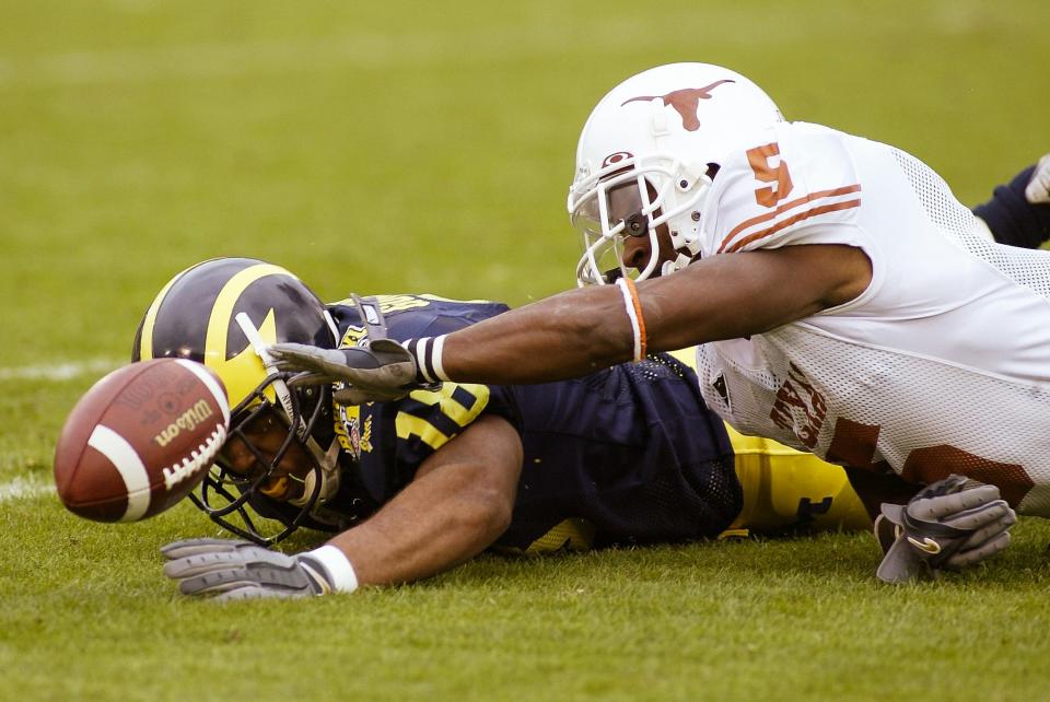 Jan 1, 2005; Pasadena, CA, USA: FILE PHOTO; Michigan Wolverines wide receiver Jermaine Gonzales (18) in action against Texas Longhorns cornerback Tarell Brown (5) during the 2005 Rose Bowl at the Rose Bowl. The Longhorns defeated the Wolverines 38-37. Mandatory Credit: Richard Mackson-USA TODAY Network