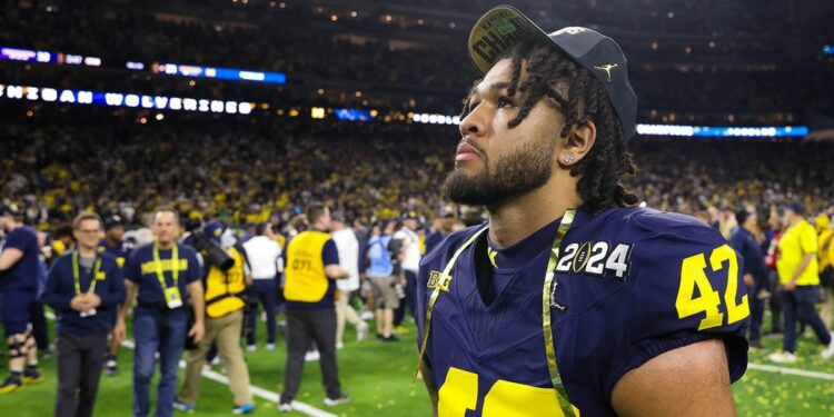 Michigan Wolverines defensive end TJ Guy (42) after the Wolverines defeated the Washington Huskies in the 2024 College Football Playoff national championship game at NRG Stadium.