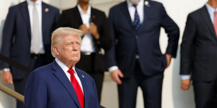 Donald Trump looks on during a wreath laying ceremony at the Tomb of the Unknown Soldier at Arlington National Cemetery on August 26, 2024 in Arlington, Virginia.