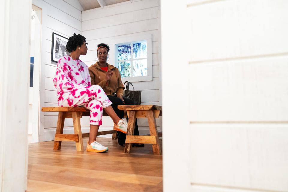 Suzanne Johnson, right, and her daughter Cameron have a discussion about the Gullah Geechee exhibit they are sitting in during a visit to the International African American Museum in Charleston, S.C., Tuesday, Jan. 23, 2024.