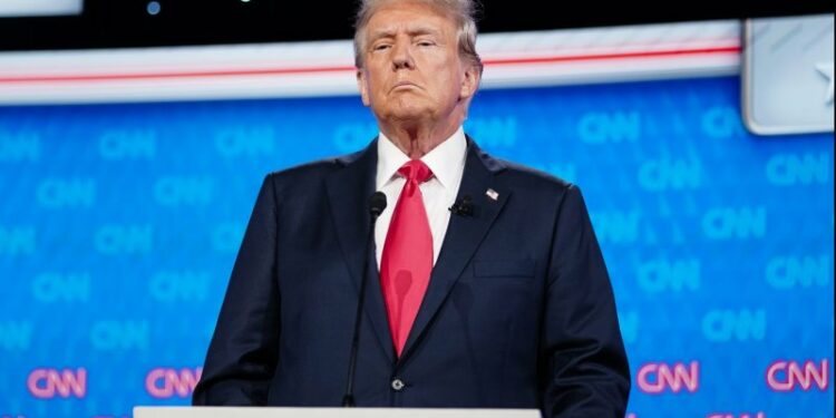 Former President Donald Trump stands on the stage during a break in the CNN presidential election debate against President Joe Biden in Atlanta, Georgia on June 27. On Tuesday, Trump said he had reached agreement on the debate rules for next month's meeting with Vice President Kamala Harris. File Photo by Elijah Nouvelage/UPI