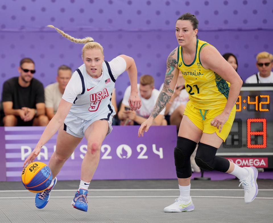 Hailey van Lith (9) drives to the basket against Australia's Marena Whittle (21) in a pool round game during the Paris 2024 Olympic Summer Games on Thursday.