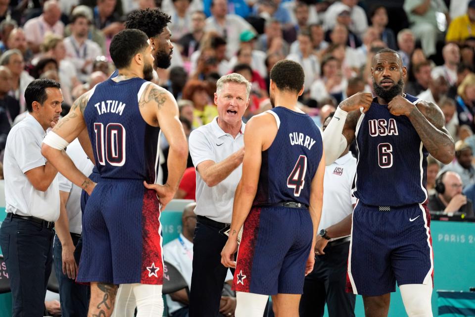 USA head coach Steve Kerr talks to Joel Embiid (11), Jayson Tatum (10), Stephen Curry (4) and LeBron James (6) in the game against Brazil in a men’s basketball quarterfinal game during the Paris Olympics.