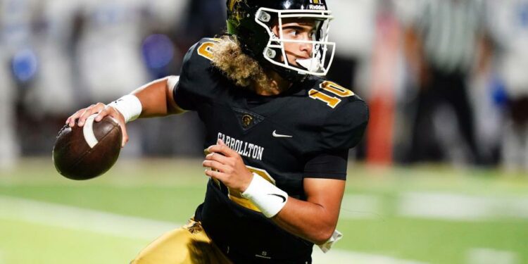 Oct 20, 2023; Carrollton, GA, USA; Carrollton Trojans quarterback Julian Lewis (10) scrambles out of the pocket against the Westlake Lions during the first half at Grisham Stadium. The 15-year-old Carrollton High student has already committed to playing for the University of Southern California Trojans and has been considered one of the top high school quarterback prospects. Mandatory Credit: John David Mercer-USA TODAY Sports