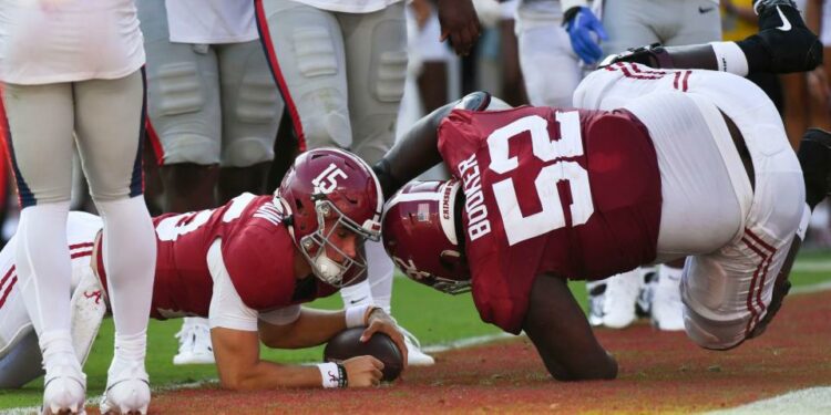 Sep 23, 2023; Tuscaloosa, Alabama, USA; Alabama Crimson Tide quarterback Ty Simpson (15) dives into the end zone with a two point conversion against Mississippi as Alabama Crimson Tide offensive lineman Tyler Booker (52) falls into the end zone with him at Bryant-Denny Stadium. Alabama defeated Mississippi 24-10. Mandatory Credit: Gary Cosby Jr.-USA TODAY Sports