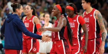 U.S. shooting guard Diana Taurasi (12) celebrates with forward guard Jackie Young (13) and forward Kahleah Copper (7) and centre Brittney Griner (15) after defeating Germany in a women's group C game during the Paris 2024 Olympic Summer Games at Stade Pierre-Mauroy.