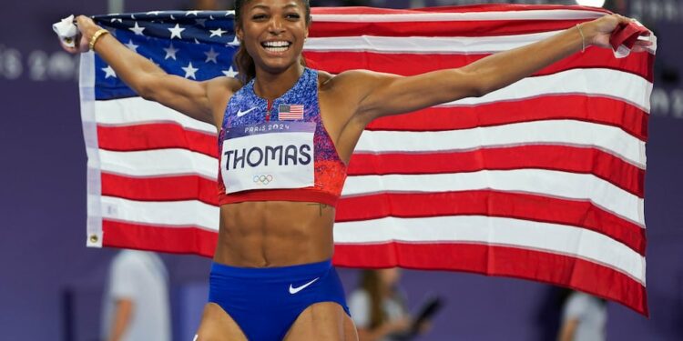 Gabrielle Thomas, of the United States, celebrates after winning the women's 200-meter final...