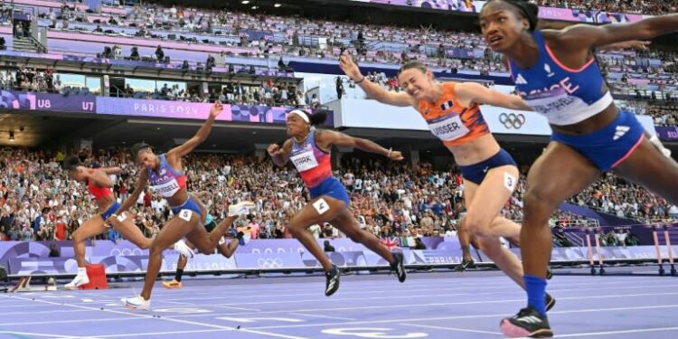 Masai Russell (2L) crosses the finish line just ahead of France's Cyrena Samba-Mayela (R) in the Olympic women's 100m hurdles (Jewel SAMAD)