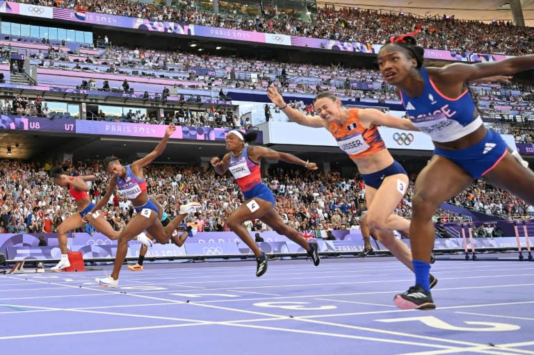 Masai Russell (2L) crosses the finish line just ahead of France's Cyrena Samba-Mayela (R) in the Olympic women's 100m hurdles (Jewel SAMAD)