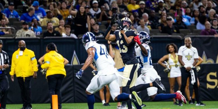 Aug 25, 2024; New Orleans, Louisiana, USA; New Orleans Saints wide receiver Equanimeous St. Brown (13) catches a touchdown against Tennessee Titans safety Shyheim Carter (28) during the first half at Caesars Superdome. Mandatory Credit: Stephen Lew-USA TODAY Sports