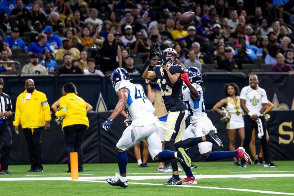 Aug 25, 2024; New Orleans, Louisiana, USA; New Orleans Saints wide receiver Equanimeous St. Brown (13) catches a touchdown against Tennessee Titans safety Shyheim Carter (28) during the first half at Caesars Superdome. Mandatory Credit: Stephen Lew-USA TODAY Sports