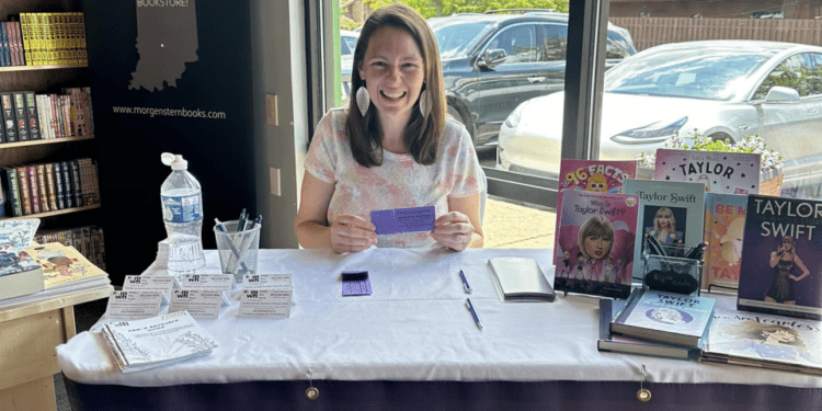 Melissa Colman mans a table at Morgenstern Books on Aug. 18, 2024, to sell raffle tickets for a chance to see Taylor Swift in Indianapolis.