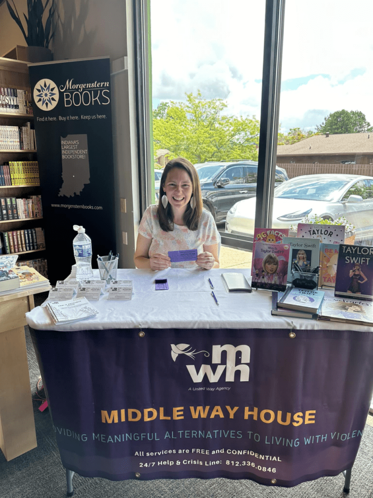 Melissa Colman mans a table at Morgenstern Books on Aug. 18, 2024, to sell raffle tickets for a chance to see Taylor Swift in Indianapolis.