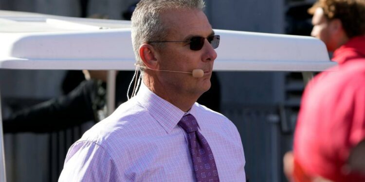 Oct 21, 2023; Columbus, Ohio, USA; Former Ohio State Buckeye football coach Urban Meyer walks to the Big Noon Kickoff show set before the Penn State Nittany Lions game at Ohio Stadium.