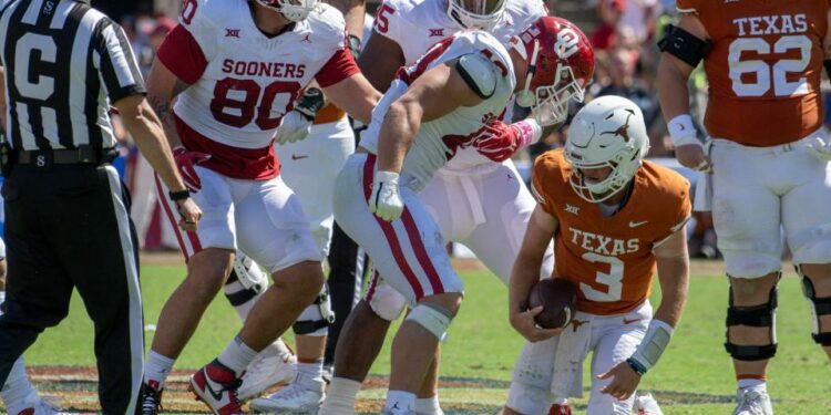 Oct 7, 2023; Dallas, Texas, USA; Oklahoma Sooners defensive lineman Ethan Downs (40) stands over Texas Longhorns quarterback Quinn Ewers (3) after Ewers is sacked for a loss during the second half at the Cotton Bowl. Mandatory Credit: Jerome Miron-USA TODAY Sports