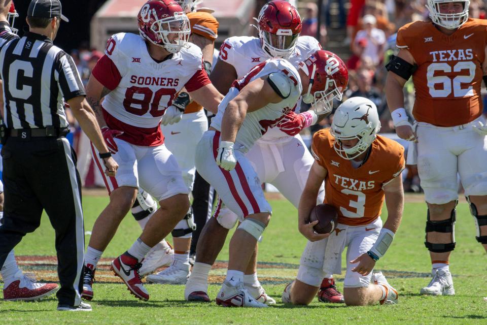 Oct 7, 2023; Dallas, Texas, USA; Oklahoma Sooners defensive lineman Ethan Downs (40) stands over Texas Longhorns quarterback Quinn Ewers (3) after Ewers is sacked for a loss during the second half at the Cotton Bowl. Mandatory Credit: Jerome Miron-USA TODAY Sports