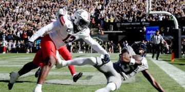 BOULDER, COLORADO - NOVEMBER 11: Jimmy Horn Jr. #5 of the Colorado Buffaloes catches a pass for a touchdown against Martell Irby #13 of the Arizona Wildcats in the first quarter at Folsom Field on November 11, 2023 in Boulder, Colorado. (Photo by Matthew Stockman/Getty Images)