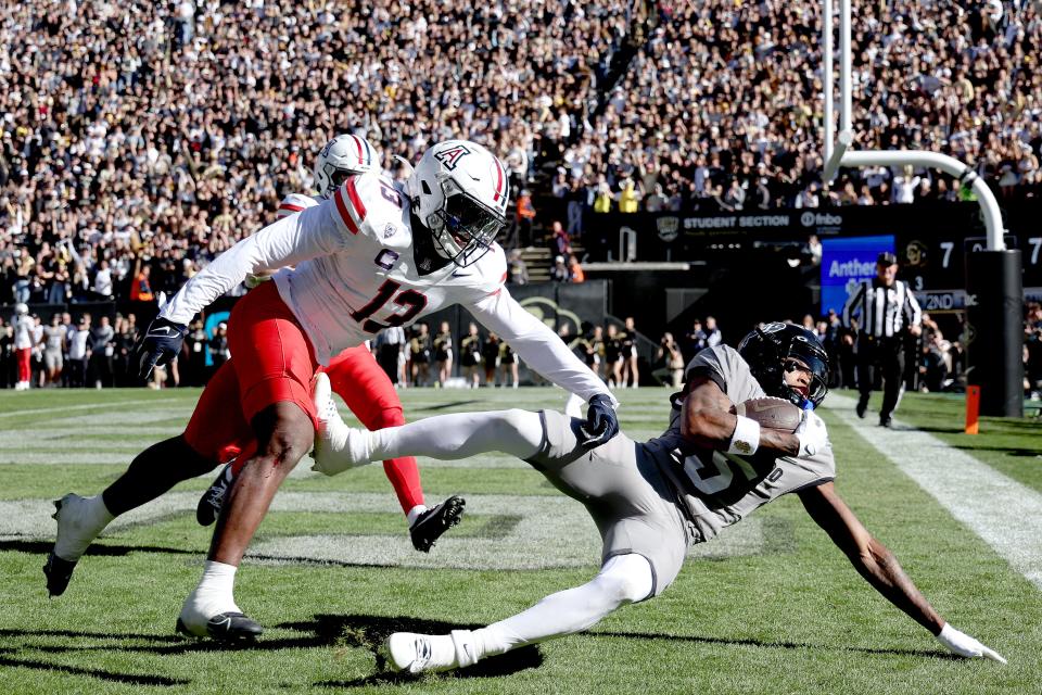 BOULDER, COLORADO - NOVEMBER 11: Jimmy Horn Jr. #5 of the Colorado Buffaloes catches a pass for a touchdown against Martell Irby #13 of the Arizona Wildcats in the first quarter at Folsom Field on November 11, 2023 in Boulder, Colorado. (Photo by Matthew Stockman/Getty Images)