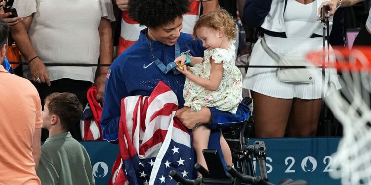 United States centre Brittney Griner (15) celebrates with Isla Taurasi, daughter of shooting guard Diana Taurasi, after defeating France in the women’s basketball gold medal game during the Paris 2024 Olympic Summer Games.