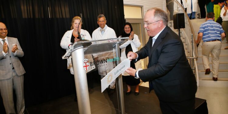 John Fernandez, president and CEO, of Lifespan, unveils the new logo for Brown University Health during a press conference on June 20, 2024.