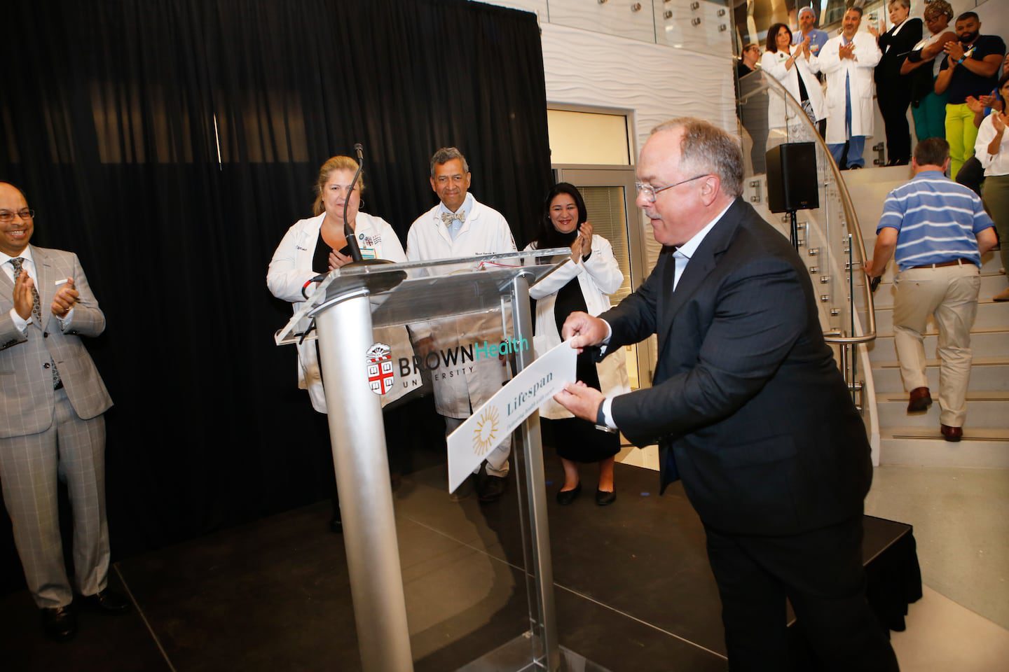 John Fernandez, president and CEO, of Lifespan, unveils the new logo for Brown University Health during a press conference on June 20, 2024.