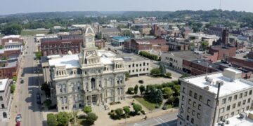 An aerial establishing shot of the Muskingum County Courthouse and clock tower in downtown Zanesville, Ohio.