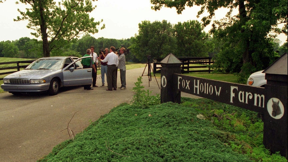 July 2, 1996; Westfield, IN; Television news media interview a police officer outside the entrance of Fox Hollow Farm in Westfield, where human bones were discovered last week. Authorities are still investigating the scene.