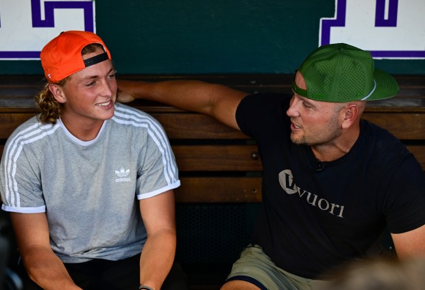 Ethan Holliday, left, talks with his father, former Colorado Rockies player Matt Holliday, before the Baltimore Orioles take on the Colorado Rockies at Coors Field in Denver on Friday, Aug. 30, 2024. (Photo by Andy Cross/The Denver Post)