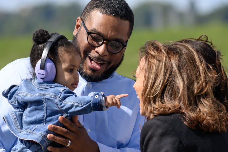 Vice President Kamala Harris greets the daughter of Pennsylvania Lt. Gov. Austin Davis (seen holding her) before departing for a Labor Day rally with labor leaders in Pittsburgh. Photo by Archie Carpenter/UPI