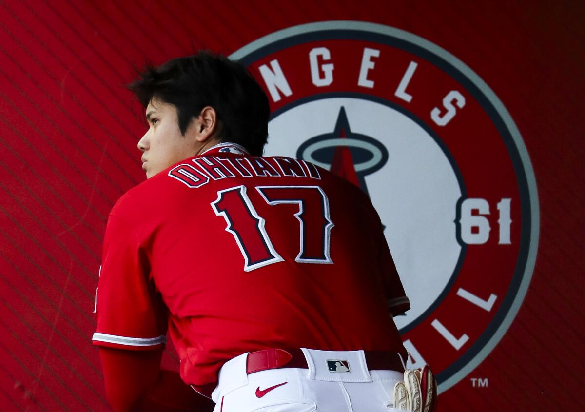 Shohei Ohtani stands in the Angels' dugout during a game against the New York Yankees.