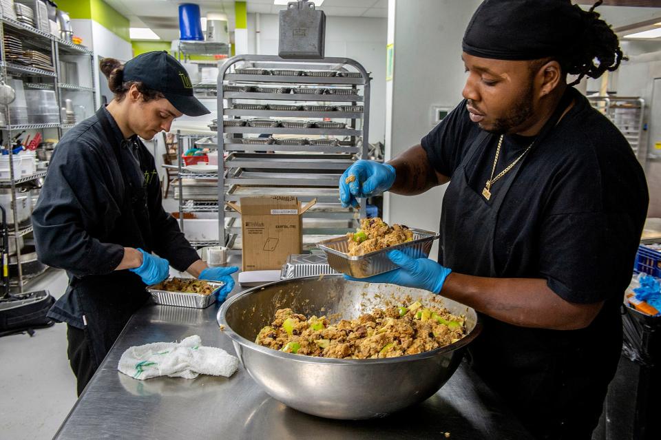 Freddie Pfeifer, left, and Rayshon Copeland, both chefs at Twist Bakery & Cafe in Millis, prepare stuffing for a new Thanksgiving turkey sandwich at the award-winning bakery, Aug. 30, 2024.