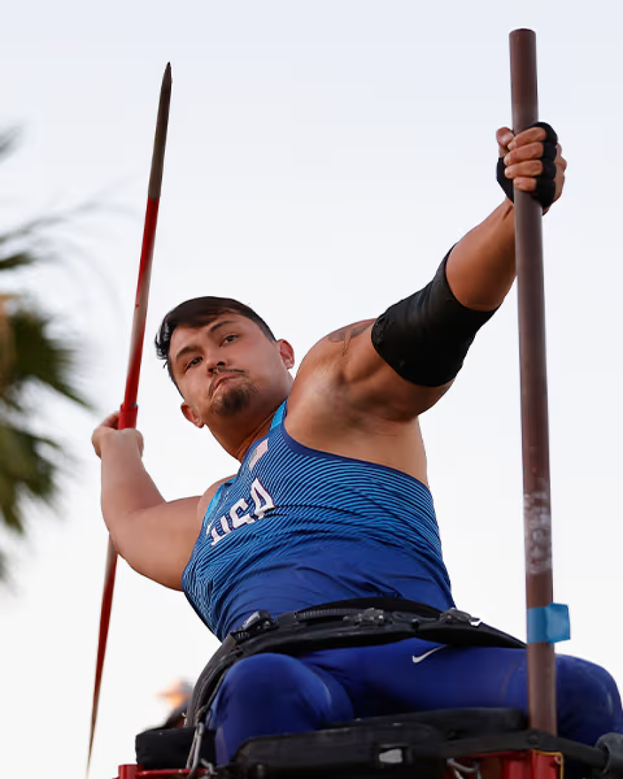 Justin Phongsavanh throws the javelin while seated in a wheelchair.