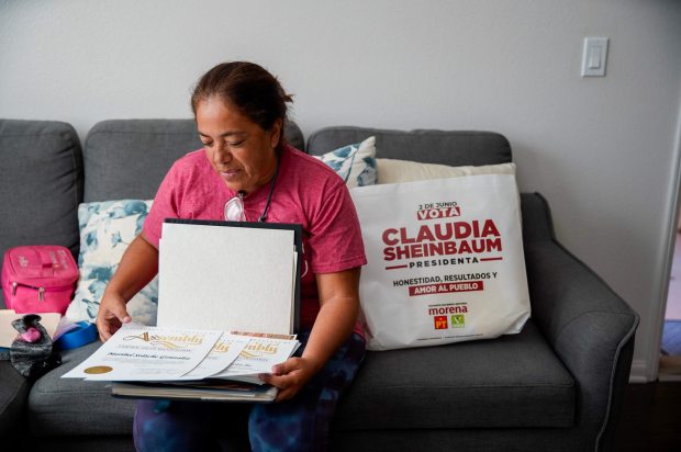 Maribel Solache, a San Marcos resident and longtime immigrant rights advocate, shows certificates she has received. (Alejandro Tamayo / The San Diego Union-Tribune)