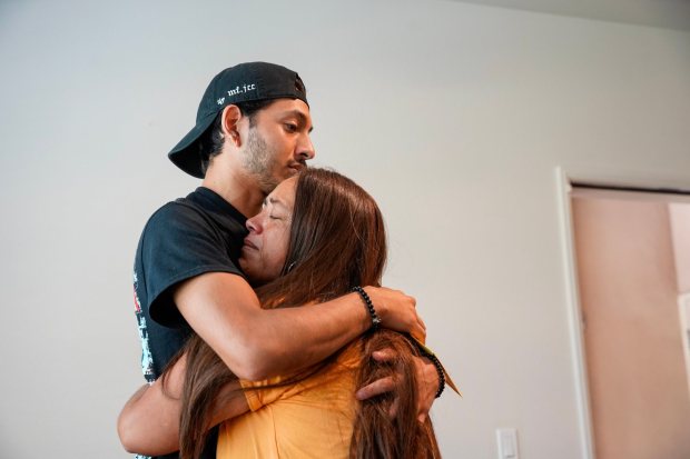 Juan Castillo Solache, 24, hugs his mother, Maribel Solache. (Alejandro Tamayo / The San Diego Union-Tribune)