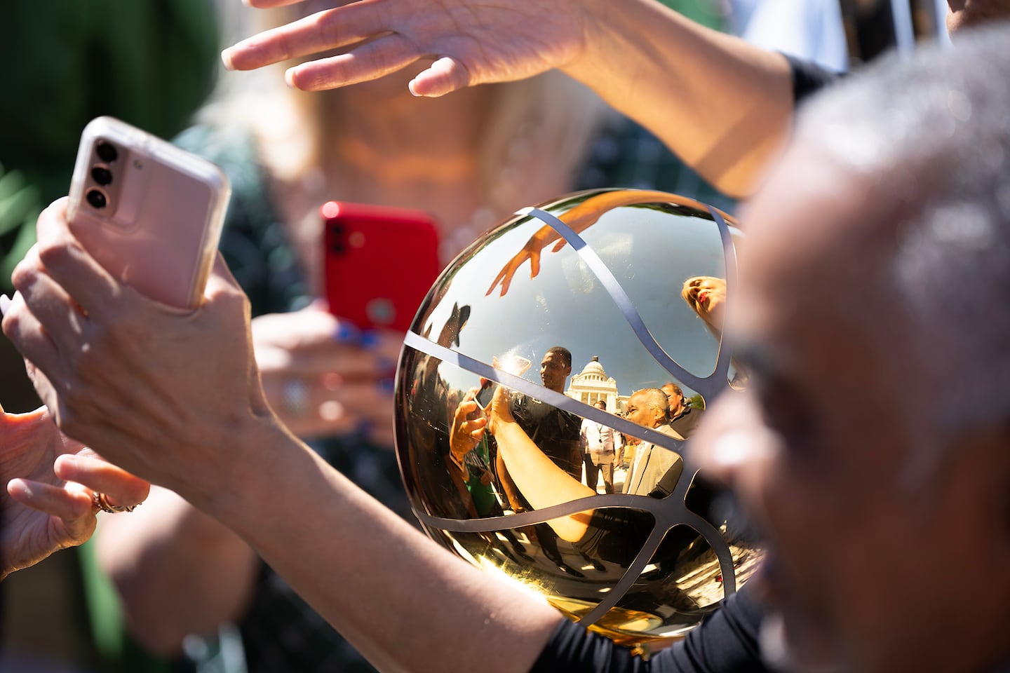 People reach out for autographs and photos of Boston Celtics Coach Joe Mazzulla, a Johnston native who brought the NBA championship trophy to the Rhode Island State House.