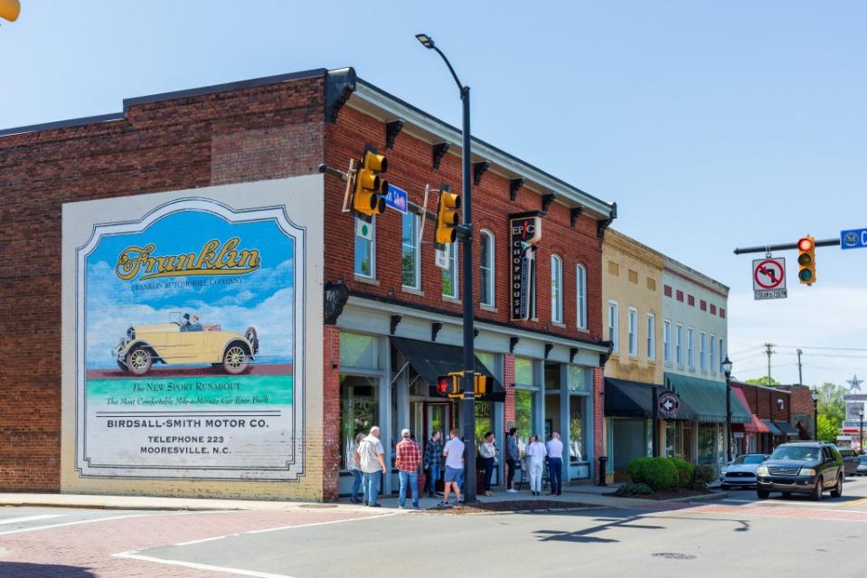 A group of people gathered on a sidewalk in front of the Epic Chophouse on Main Street in Mooresville. Getty Images