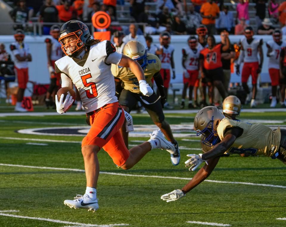 Cocoa's Jayvan Boggs escape tacklers to run for a touchdown during a game with Mainland at Daytona Stadium in Daytona Beach, Friday, Aug. 30, 2024.