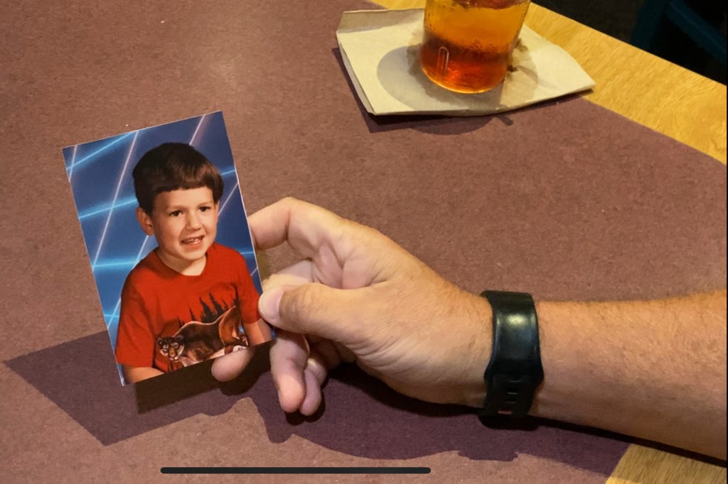 Blair County Sheriff Jim Ott holding up a picture of his son Josh.