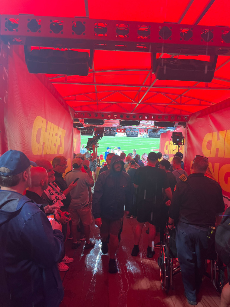 press huddle in a red tented area