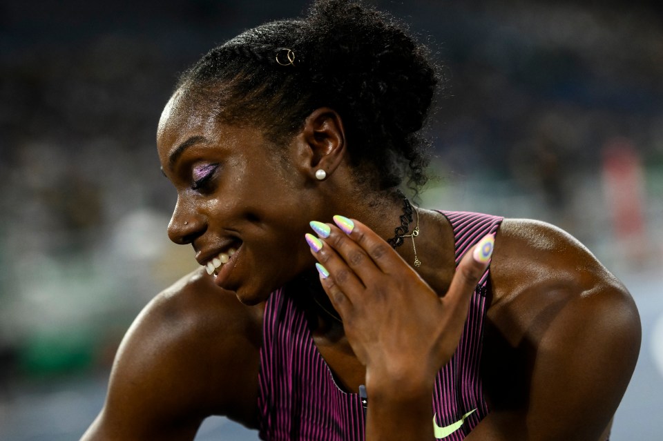 Brittany Brown poses for the camera with rainbow nails