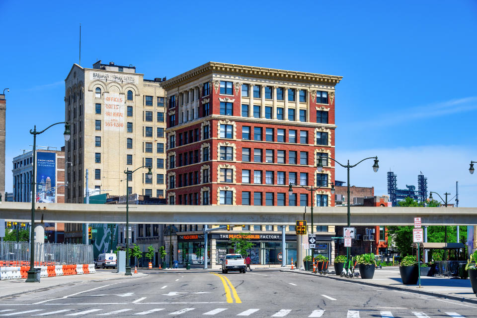 Detroit, USA - July 20, 2024: Cityscape with famous buildings in the downtown district. Symmetric view of a city street.