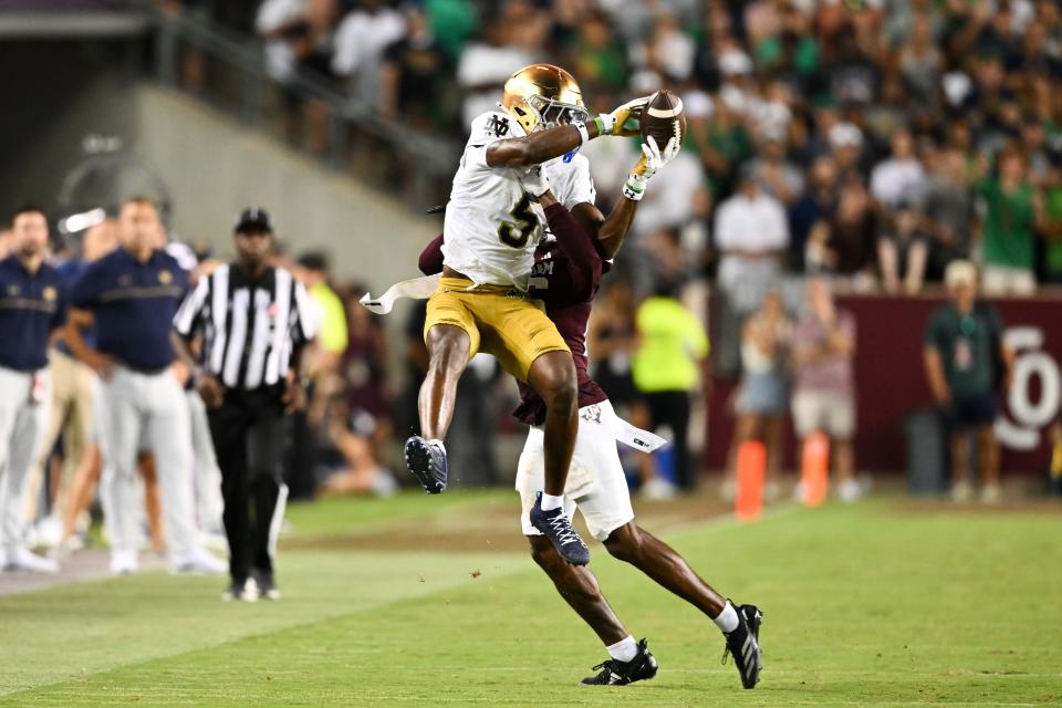 Aug 31, 2024; College Station, Texas, USA; Notre Dame Fighting Irish wide receiver Beaux Collins (5) catches a pass as Texas A&M Aggies defensive back Dashawn Fillmore (26) attempts to break up the play in the fourth quarter at Kyle Field. Mandatory Credit: Maria Lysaker-USA TODAY Sports