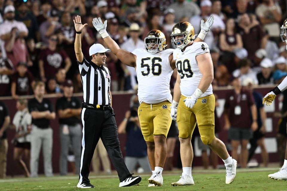 COLLEGE STATION, TEXAS - AUGUST 31: Howard Cross III #56 of the Notre Dame Fighting Irish celebrates his sack with Rylie Mills #99 against the Texas A&M Aggies at Kyle Field on August 31, 2024 in College Station, Texas. (Photo by Jack Gorman/Getty Images)