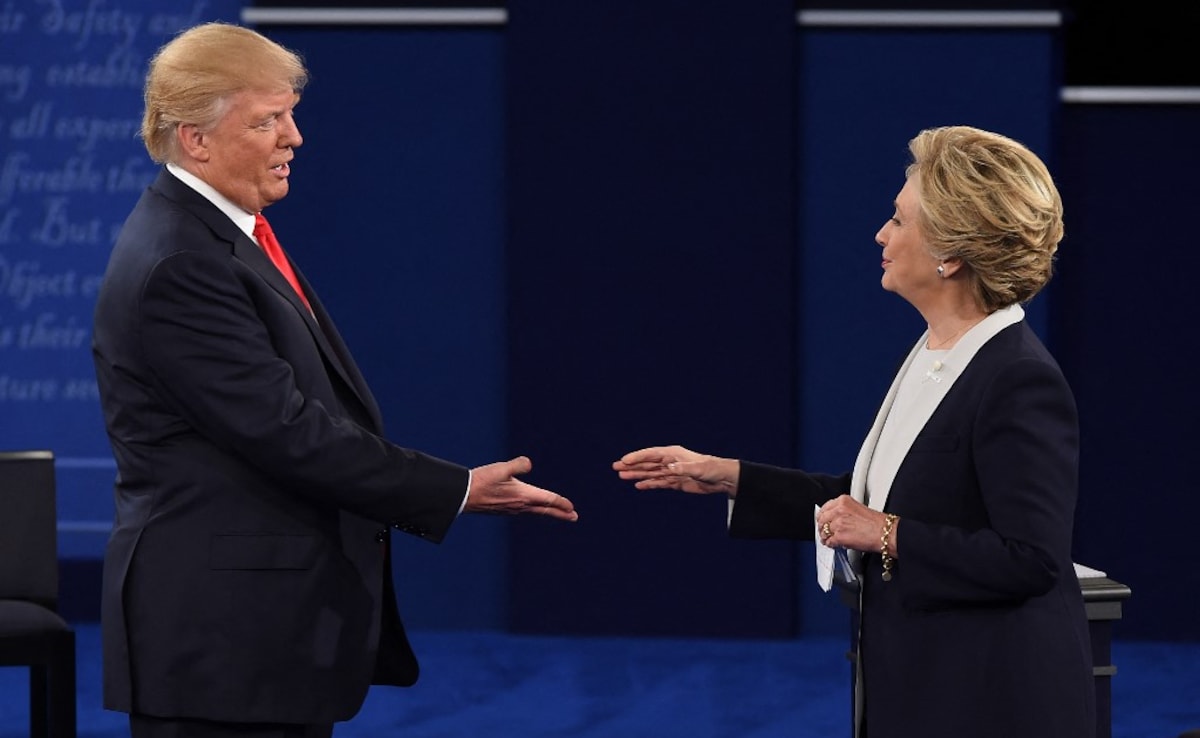 The then US Democratic presidential candidate Hillary Clinton and US Republican presidential candidate Donald Trump shakes hands after the second presidential debate at Washington University in St. Louis, Missouri, on October 9, 2016