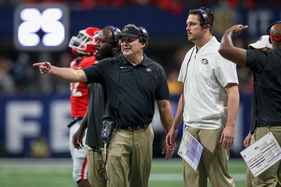 Dec 7, 2019; Atlanta, GA, USA; Georgia Bulldogs head coach Kirby Smart talks to defensive coordinator Dan Lanning against the LSU Tigers in the third quarter in the 2019 SEC Championship Game at Mercedes-Benz Stadium. Mandatory Credit: Brett Davis-USA TODAY Sports