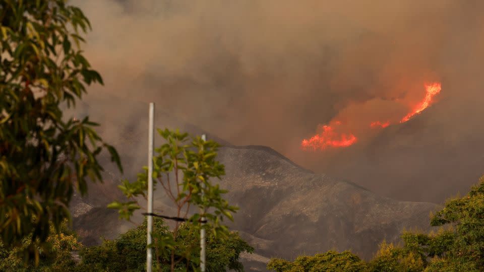 People look on, as the Airport Fire burns in the hills of Orange County, California, on September 9. - Mike Blake/Reuters