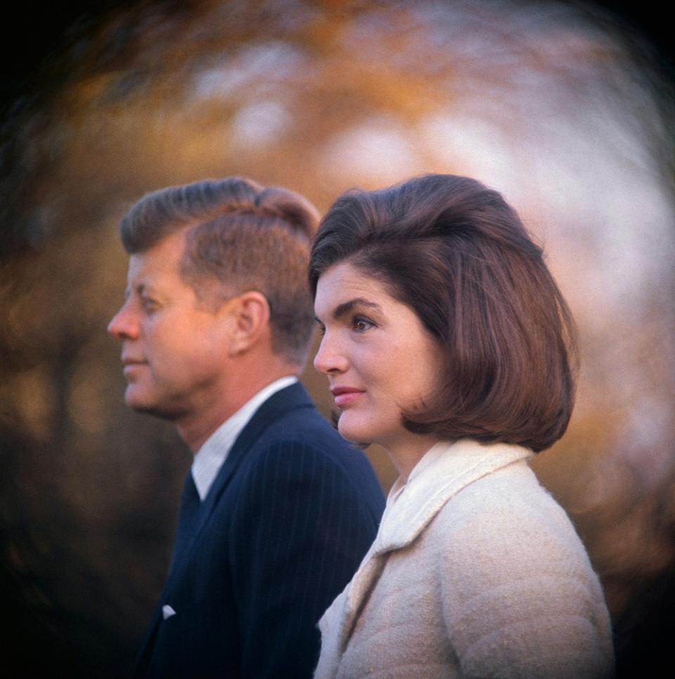 A close-up of President JFK and Jackie Kennedy looking away from the camera wearing formal attire